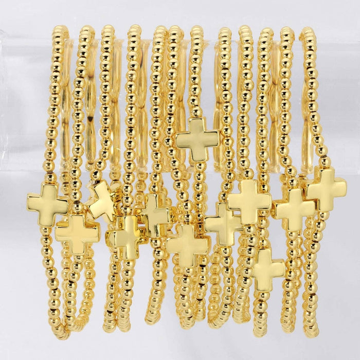 beaded stretch bracelet with single balanced gold cross