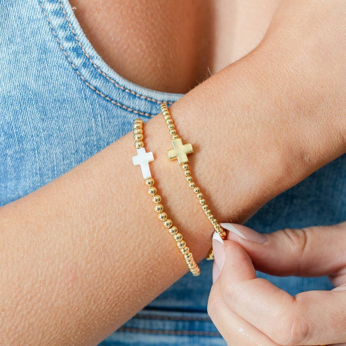 beaded stretch bracelet with single balanced gold cross